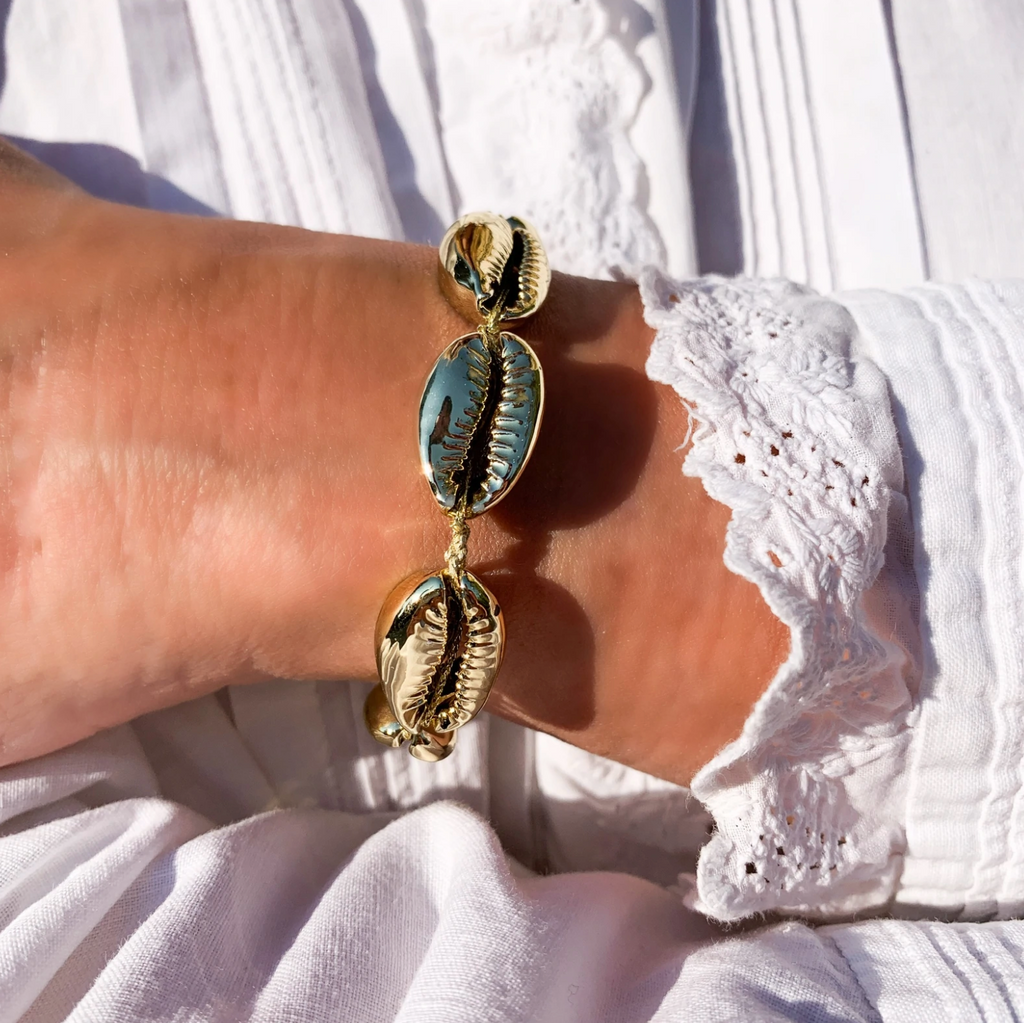 gold cowries on gold threaded bracelet